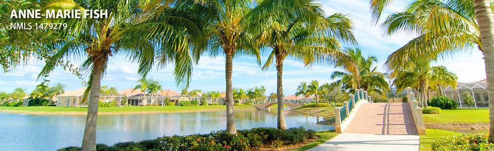 Florida neighborhood community entrance with palm trees along the water