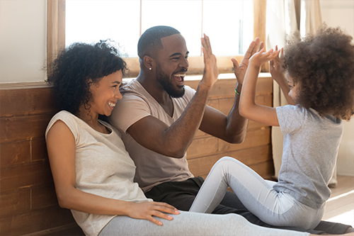 Family giving high-fives in their new home