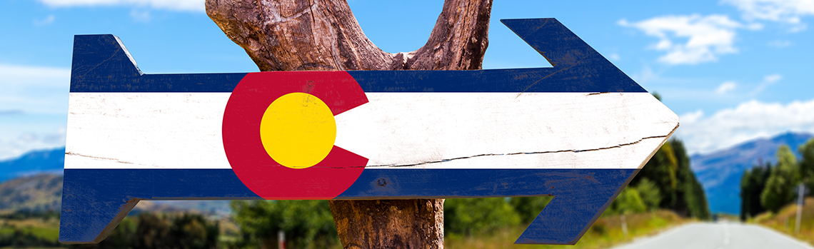 Colorado flag wooden sign on the road