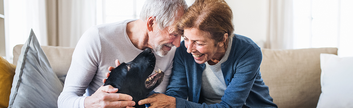 Retired couple enjoying their sofa and dog