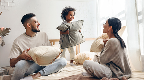 family having a pillow fight